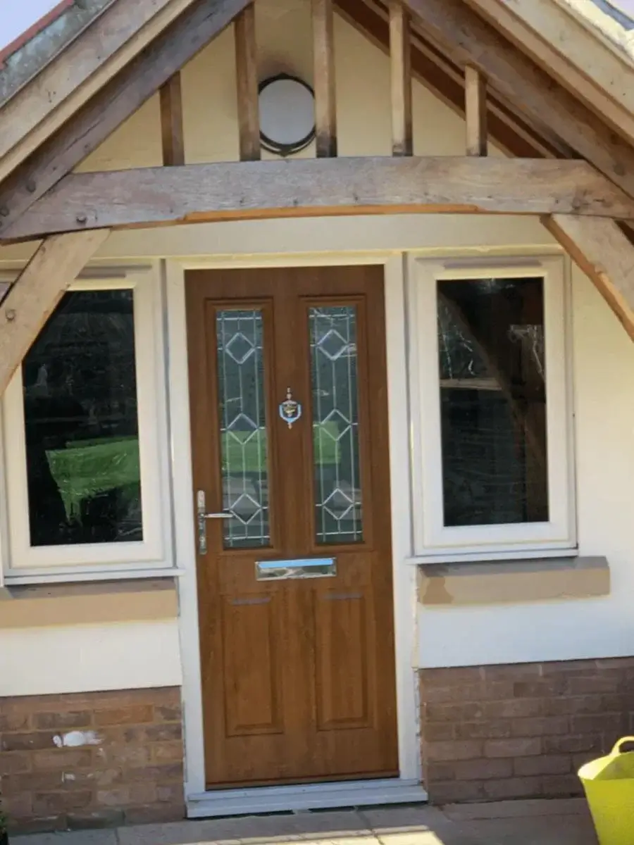 Modern composite front door installation with secure glazing panels on a residential property in Norfolk. Crafted by Norfolk Exterior Solutions